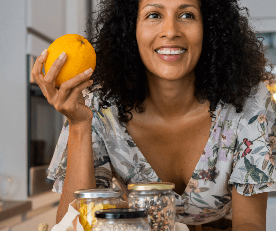 A happy, smiling woman at home after shopping sustainable food products and focusing in meat-free meals.